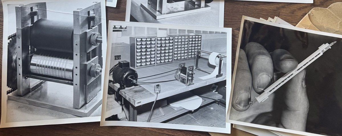 A spread of black-and-white laboratory photographs: a roller winding machine, an electronics workbench lined with component drawers, and a hand holding a small precision component.